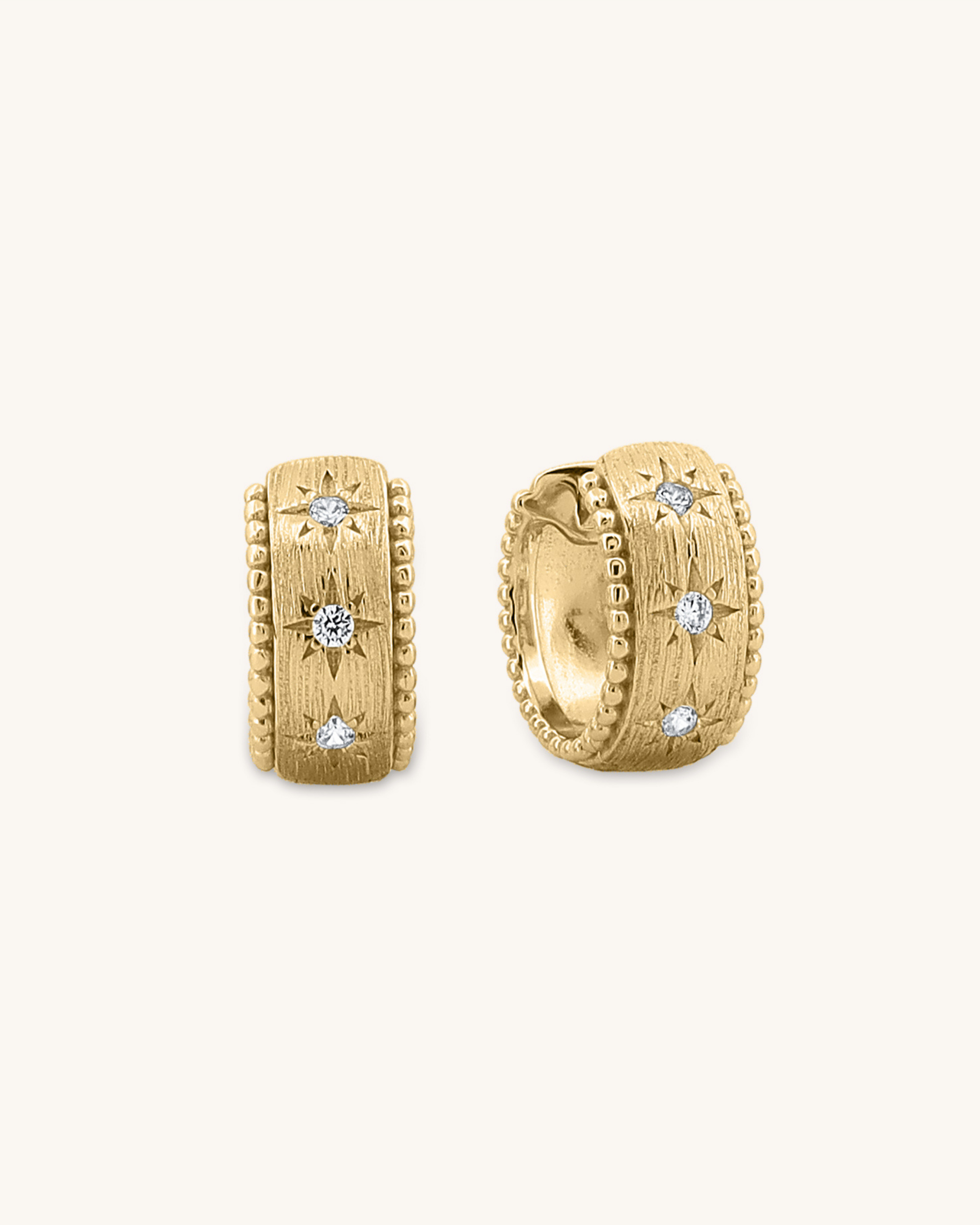 Variant_Gold vermeil
Stardust Huggie earrings with brushed finish, star-etched details, and beaded edges